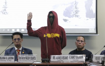 <p><strong>HOODED EX-REBEL</strong>. "Allem", one of the former rebels, testifies on Wednesday (Aug. 14) before a Senate hearing on reports of recruitment of the New People's Army in schools. <em>(PNA photo by Avito Dalan)</em></p>