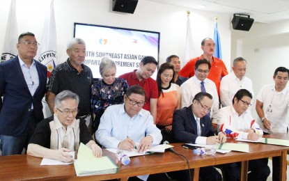 <p><strong>TRIPARTITE AGREEMENT. </strong> Officials of the Philippine Sports Commission, Philippine Olympic Committee and Philippine SEA Games Organizational Committee Foundation, Inc. formally sign a tripartite agreement at the PSC Conference Room at the Rizal Memorial Sports Complex, Manila on Wednesday (Aug. 14, 2019).  Signed by (seated from left) POC chairman Steve Honteveros, PSC chairman William 'Butch' Ramirez, POC president Abraham Tolentino and Phisgoc chief executive officer Ramon M. Suzara, the agreement aims to provide smooth hosting of the 30th Southeast Asian Games from Nov. 30 to Dec. 11 this year. <em>(PNA photo by Jess M. Escaros Jr.)</em></p>