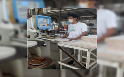 <p><strong>DOST SETUP.</strong>  An artisan of the San Jose Kitchen Cabinet manufacturing factory in Carmona, Cavite enjoys science and technology (S&T)-based wood cutting machine operation and assembly for the furniture venture through the support of the Department of Science and Technology (DOST) Calabarzon’s Small Enterprise Technology Upgrade Program (SETUP). The DOST SETUP assistance enabled the furniture business to acquire automatic edge bander worth PHP1.998 million, along with various trainings provided for staff capability development. <em>(Photo courtesy of DOST4A-PARCU)</em></p>
<p> </p>