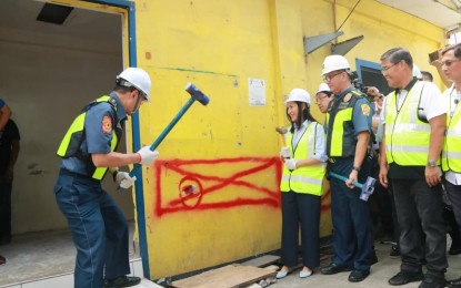 <p><strong>DEMOLISHED. </strong>National Capital Region Police Office chief, Guillermo Eleazar, assist in the demolition of the barangay hall of Damayang Lagi in Quezon City on Friday (August 16, 2019). The demolition of the barangay hall, which was found encroaching on a sidewalk, is in compliance with President Rodrigo Duterte's order to clear public roads of obstructions. <em>(Photo courtesy: NCRPO PIO)</em></p>