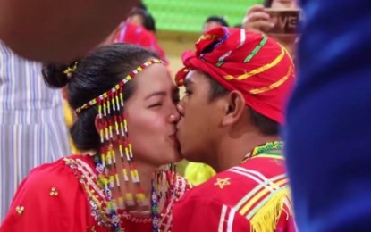 <p><strong>SEALED.</strong> A Manobo couple kiss each other during the mass wedding for Indigenous Peoples (IP) in Kidapawan City on Sunday (Aug. 18, 2019). A total of 44 IP couples got married in the wedding ceremony sponsored by the Kidapawan local government. <em><strong>(Photo courtesy of Kidapawan CIO)</strong></em></p>