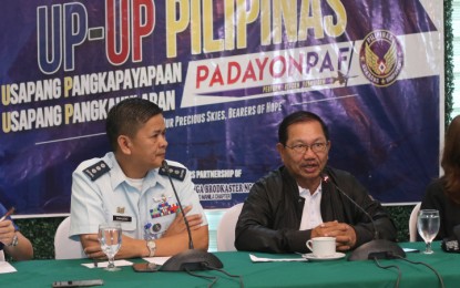 <p><strong>BARTER TRADE</strong>. Mindanao Development Authority Chair Emmanuel "Manny" Piñol is eyeing to implement barter trading for fruits and other agricultural products between the entire island region of Mindanao and Luzon. In photo, the former Agriculture chief (right) shares with Usapang Pangkapayapaan, Usapang Pangkaunlaran (UP, UP) Pilipinas of the Philippine Air Force Virtual TV host (left) Col. Geronimo Zamudio that MinDA will lead a fruit festival in Baguio City on August 24-25, 2019. <em>(Contributed Photo from Philippine Air Force)</em></p>
