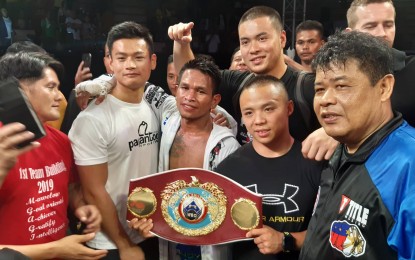 <p><strong>STILL CHAMP</strong>. John Riel Casimero pose with his camp after successfully defending his WBO interim bantamweight title at the San Andres Sports Complex in Manila on Saturday night (Aug. 24, 2019).  Casimero knocked out Mexico's Cesar Ramirez in 10th round. <em>(PNA Photo by Ivan Saldajeno)</em></p>
<p><em> </em></p>
