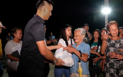 <p><strong>RELIEF DISTRIBUTION</strong>. Ilocos Norte Governor Matthew Joseph Manotoc leads distribution of relief packs to flood victims on Sunday night (Aug. 26, 2019).  Tropical Storm Ineng left two people dead and over P1.1 billion worth damages damages in infracture and agriculture. <em>(Photo courtesy of Ilocos Norte provincial Government) </em></p>