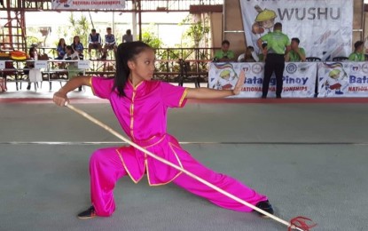 <p><strong>TRIPLE GOLD.</strong> University of Baguio Science High School’s Aleca Breanna Dumseng is one of two Baguio athletes to earn three golds in the Batang Pinoy national finals after ruling the 1st set quiang shu/gun shu (long weapon) on Wednesday. Team wushu has so far earned 12 golds aside from winning six silver and two bronze medals.<em> (Photo courtesy of Eleazer Dumseng)</em></p>
