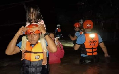 <p><strong>MASSIVE FLOODING.</strong> The Davao City Police Office Search and Rescue Team rescues a family during a flash flood in a barangay in Davao City on Wednesday evening (Aug. 28, 2019). <em>(Photo courtesy of DCPO PIO)</em></p>