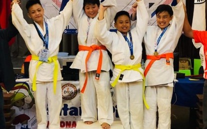 <p><strong>SWEET GOLD</strong>. Ten-year-old Paglaya de Villa is flanked by his vanquished opponents in the under 50 kilograms of the judo competition of the Batang Pinoy national finals Thursday in Puerto Princesa, Palawan. The grade 4 is following the footsteps of elder sister Pagibig, who is a member of the University of the Philippines-Diliman's judo team, the defending UAAP champion, and an individual bronze medalist of the same league. <em>(Photo courtesy of Marilen de Villa)</em></p>