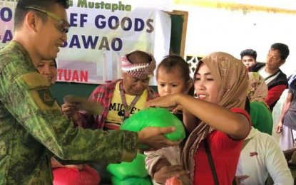 <p><strong>HELPING HAND.</strong> A soldier of the Army’s 601st Infantry Brigade hands over a relief pack to one of the families affected by the recent conflict in Barangay Dasawao, Shariff Saydona Mustapha, Maguindanao. More than 1, 000 families benefited from the outreach program spearheaded by the local government in the area on Friday (Aug. 30, 2019). <em>(Photo courtesy of SSM LGU)</em></p>