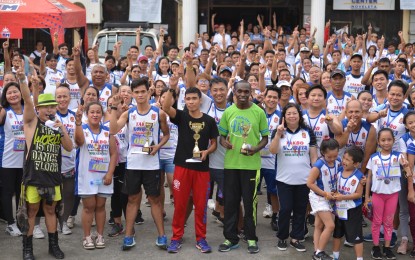 <p><strong>RUN VS. DRUGS</strong>. The winners and runners pose with Noveleta Mayor Dino Reyes Chua and Police Capt. Rosalino Panlaqui, local police chief during the awarding ceremony of the 'Takbo Noveleta Fun Run' Saturday, August 31, 2019 at the town plaza. <em>(PNA photo by Dennis Abrina)</em></p>