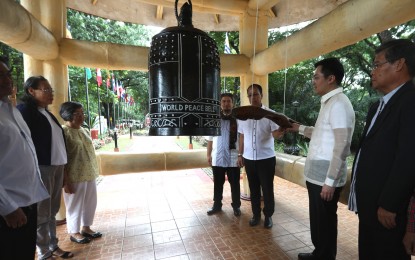 <p><strong>WORLD PEACE BELL. </strong> Cabinet Secretary Karlo Alexie B. Nograles (second from right) and Presidential Adviser on Peace Reconciliation and Unity Carlito G. Galvez Jr. (third from right) lead the ringing of the world peace bell to kick off the 2019 National Peace Consciousness Month during a ceremony held at the Quezon City Memorial Circle on Monday (Sept. 2, 2019). During the event, both Nograles and Galvez highlighted the Duterte administration's peace achievements, including the establishment of the Bangsamoro Autonomous Region of Muslim Mindanao. <em>(PNA photo by Rico H. Borja)</em></p>