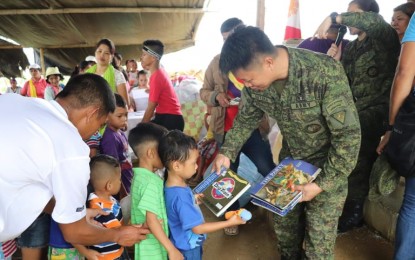 <p><strong>REACHING OUT.</strong> Children of Supanga Village, Calinog town, Iloilo receive educational materials from Lt. Col. Joel Benedict Batara, commander of the Philippine Army's 61IB on Friday (Aug. 30, 2019). 1Lt. Hazel Joy Durotan said people in far-flung villages were grateful for the help facilitated by the Army's Community Support Program (CSP) teams. <em>(Photo courtesy of 61IB)</em></p>