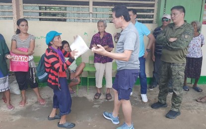 <p><strong>DISPLACED.</strong> Mayor Melecio Yap Jr. (center) of Escalante City, Negros Occidental; and Lt. Col. Emelito Thaddeus Logan (right), commanding officer of 79th Infantry Battalion, visit displaced residents in one of the evacuation centers on Monday (Sept. 2, 2019). The visit followed an encounter between Philippine Army troops and New People’s Army fighters in Sitio Morino, Barangay Paitan over the weekend. <em>(Photo courtesy of 79th Infantry Battalion, Philippine Army)</em></p>