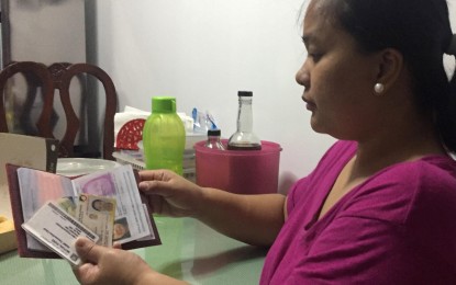 <p><strong>NATIONAL ID SYSTEM. </strong>May Pagkatipunan-Aceron, 38, says she keeps four government issued IDs - Pag-ibig ID, Passport, SSS Unified ID and PhilHealth ID - to ensure that she has enough proof of identity for public and private transactions. On Aug. 6, 2018, President Rodrigo Duterte signed Republic Act 11055 creating PhilSys or the National ID, which serves as a single official identification card for all citizens and foreign residents in the country. <em>(Photo courtesy of May Pagkatipunan-Aceron)</em></p>