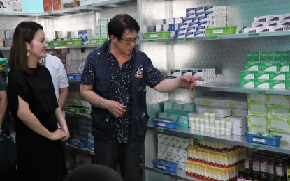 <p><strong>BOTIKA NG BAYAN. </strong>Department of Health Region IV-A (Calabarzon) Director Eduardo Janairo (right) shows to Municipal Mayor Jasmin Angelli Maligaya-Bautista (left) the color-coded medicines to differentiate which ones were purchased by the DOH and by the local government, during the opening of the Botika ng Bayan in Magallanes, Cavite on Monday (September 2, 2019). A total of PHP351,752 worth of medicines were turned-over by the regional office. <em>(Photo courtesy of DOH Calabarzon PIO)</em></p>