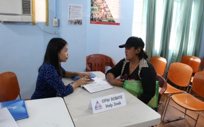 <p><strong>REBATE PROGRAM FOR OFWs.</strong> An employee of the Overseas Workers Welfare Administration (OWWA) assists an overseas Filipino worker during the implementation of the agency's rebate program in Central Luzon on Monday, September 2, 2019. Qualified members are those who are at least with OWWA for 10 years with five or more contributions until December 2017 and those who have not availed of any program or benefit from OWWA.<em> (Photo courtesy of OWWA-3)</em></p>