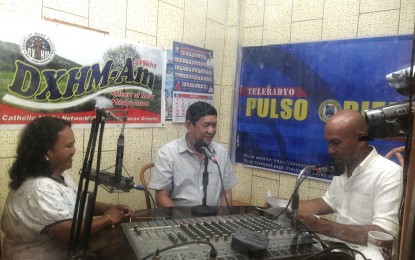 <p><strong>STEPPING UP INFO DISSEMINATION.</strong> Davao Oriental Governor Nelson Dayanghirang graces the pilot episode of the "Pulso Oriental” radio program in Mati City on Monday (Sept. 2, 2019). Karen Lou Deloso, Davao Oriental provincial information office head, said the program was redesigned to complement the localized implementation of the President’s Executive Order 70 or the Whole-of-Nation Approach to attain sustainable peace and end local communist armed conflict.<em> (Photo courtesy of Davao Oriental PIO)</em></p>