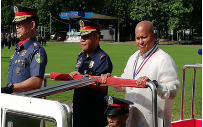 <p><strong>DEATH PENALTY.</strong> Senator Ronald “Bato” Dela Rosa (right) joins Police Regional Office (PRO-4A) Calabarzon Director, Brig. Gen. Edward E. Carranza (center) and Col. Serafin F. Petalio II, head of the Regional Intelligence Division (left), during the 118th Police Service Anniversary celebration at Camp Gen. Vicente Lim in Calamba City on Thursday (Sept. 5, 2019).  The former national police chief defended his proposed bill calling for the re-imposition of the death penalty for drug traffickers. <em>(Photo by Saul E. Pa-a)</em></p>