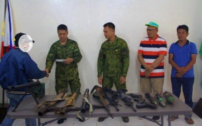 <p><strong>BIFF SURRENDER</strong>. Col. Jose Narciso (2nd left), 601st Army Brigade commander, hands over an undisclosed amount of assistance to a BIFF member (left) during surrender rites as Lt. Col. Elmer Boongaling and local officials look on Saturday (Sept. 7, 2019). A total of 14 BIFF members voluntarily surrendered to military and local officials in Maguindanao on Saturday. <em>(Photo courtesy of 33IB)</em></p>