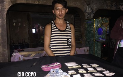 <p><strong>HIGH-VALUE TARGET.</strong> A photo released by the Criminal Intelligence Branch shows Jumar Abadiano Canoy, 25, with the illegal drugs confiscated from him during a buy-bust operation on Monday (Sept. 9, 2019). Canoy is considered by the police as a regional-level high-value target.<em> (Photo courtesy of Romeo Marantal Facebook page)</em></p>
