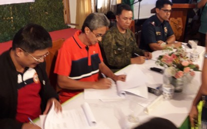 <p><strong>COMMITMENT VS. INSURGENCY.</strong> Officials of the provincial government and agencies, led by (from left to right) DILG provincial director Ofelio A. Tactac, Governor Gerardo Noveras, Lt. Col. Reandrew P. Rubio, Executive Officer of 703rd Brigade, and Col. Engelbert Z. Soriano, provincial director of Aurora Police Provincial Office, sign the joint implementing plan of the peace, development peace, law enforcement and development support (PLEDS) cluster in Aurora to solve the decades-old insurgency problem. The signing was held at the AMCO Beach Resort in Barangay Sabang, Baler, Aurora on Thursday (Sept. 12). <em>(Photo by Jason de Asis)</em></p>
