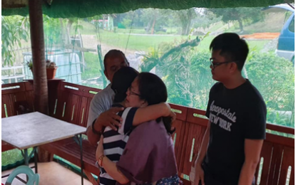 <p><strong>SURRENDER.</strong> Twenty-four-year-old Alexandria Padilla Pacalda alias “Cosette/Cris,” reunites with her family after abandoning the New People’s Army (NPA) communist terrorist group. The campus activist-turned-rebel voluntarily surrendered to Army and Philippine National Police troops in General Luna, Quezon on Sept. 15, 2019. <em>(Photo from the “Hands Off Our Children” FB page)</em></p>