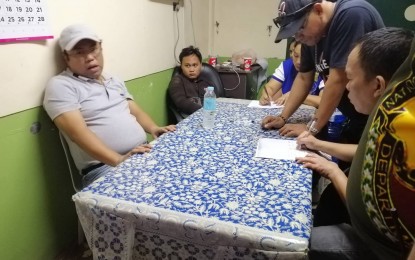 <p><strong>ARRESTED.</strong> Davao del Sur 2nd District Board Member Arvin “Jun Blanco” Malaza (extreme left) was arrested on Wednesday (September 18) during an entrapment operation his own radio station in Digos City. National Bureau of Invetigation in Region 11 (NBI-11) said the arrest was due to the resumption of investment solicitation activities of the Kapa Community Ministry International Inc., which the government shut down earlier for fraudulent activities. <em>(PNA Photo by Che Palicte)</em></p>