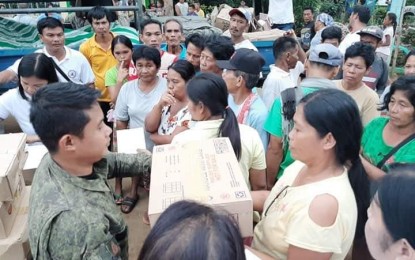 <p><strong>ASSISTANCE.</strong> Hundreds of residents of two remote villages in Escalante City, Negros Occidental receive assistance from the Philippine Army and the city government. The residents were displaced following an encounter between government troops and New People’s Army fighters last August 31. <em>(File photo courtesy of 79IB, Philippine Army)</em></p>
