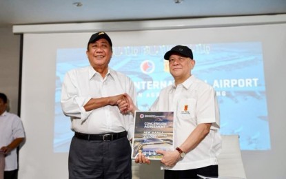 <p>Department of Transportation Secretary Arthur Tugade and San Miguel Corporation President and Chief Operating Officer Ramon S. Ang <em>(Photo courtesy of DOTr)</em></p>
