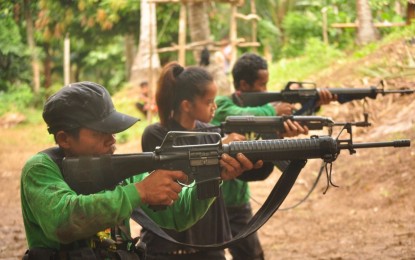 <p><strong>NPA TRAINING</strong>. Alexandrea Pacalda (middle) is seen undergoing weapons training with the New People's Army, in an undated photo shared by the military's 201st Infantry Brigade during her surrender to authorities in General Luna town, Quezon on September 14. </p>