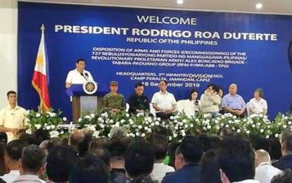 <p><strong>PROTECTION FOR EX-REBELS.</strong> President Rodrigo Duterte pledges protection for the 727 decomissioned members of the Revolutionary Proletarian Army – Alex Boncayao Brigade (RPA-ABB) or Kapatiran at Camp General Macario B. Peralta Jr. in Jamindan, Capiz on Thursday (Sept. 19, 2019). The former rebels surrendered a total of 315 long and short firearms from the Western and Central Visayas regions. <em>(PNA photo by Gail Momblan)</em></p>