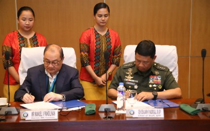 <p><strong>IMPROVING HEALTH SERVICES FOR TROOPS.</strong> Armed Forces of the Philippines (AFP) Chief of Staff, Gen. Benjamin Madrigal Jr. (right) and Makati Medical Center Foundation (MMCF) chairman Manny Pangilinan (left) sign an agreement on strengthening the capabilities of military hospitals and treatment facilities nationwide, in Camp Aguinaldo, Quezon City on Friday (Sept. 20, 2019). The partnership has benefited the AFP through cross-training, donations of medical equipment, employment of joint disaster preparedness measures, and computerization of medical records.<em> (Photo courtesy of the AFP Public Affairs Office)</em></p>