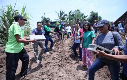 <p><strong>BAYANIHAN SA PAARALAN.</strong> Residents and provincial employees join the ceremonial passing of hollow blocks as a sign of 'bayanihan' to commence the construction of two classrooms in Sitio Bongloy, Pagsabangan in New Bataan, Compostela Valley on Friday (Sept. 20, 2019). The Bayanihan Para sa Paaralan is a program of the provincial government to address the shortage of classrooms in the different public schools with the assistance of the local business sector. <em>(Photo courtesy of Gov. Jayvee Tyron Uy)</em></p>