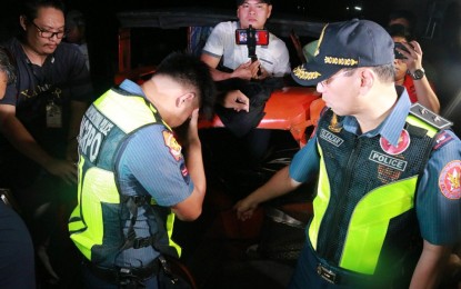 <p><strong>TONGUE-LASHING.</strong> NCRPO chief, Maj. Gen. Guillermo Eleazar scolds a cop caught sleeping on duty in Las Piñas City on Monday (Sept. 23, 2019). The cops are set to face administrative charges for neglect of duty. <em>(Photo courtesy of NCRPO)</em></p>