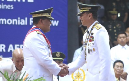 <p><strong>CHANGING OF GUARDS</strong>. Incoming Armed Forces of the Philippines chief of Staff, Lt. Gen. Noel Clement (left) and outgoing AFP chief, Gen. Benjamin Madrigal Jr., shake hands during the formal Change of Command ceremony at the AFP headquarters in Camp Aguinaldo, Quezon City on Tuesday (Sept. 24). Clement, a member of Philippine Military Academy Class of 1985, vows to end insurgency threats during his watch. <em>(PNA photo Joey O. Razon)</em></p>