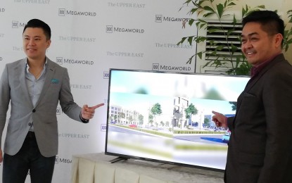 <p><strong>OFFICE TOWERS.</strong> Kevin Tan (left), chief strategy officer of Megaworld, and Roland Tiongson, first vice president of Megaworld Premier Offices, on Monday (Sept. 23, 2019) show the drawings of the two office towers that will rise inside The Upper East township in Bacolod City in 2022. Worth PHP1.2 billion, the structures are considered to be the most modern offices to rise in Bacolod. <em>(PNA photo by Nanette L. Guadalquiver)</em></p>