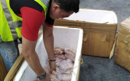 <p><strong>TO BE RETURNED.</strong> A member of the Provincial African Swine Fever (ASF) Task Force prepares the pork products that arrived at the Bacolod Bredco Port on Wednesday (Sept. 25, 2019) to be shipped back to Manila. Negros Occidental has banned the entry of pork and its by-products from Luzon for 90 days starting September 11.<em> (Photo courtesy of NegOcc Provincial ASF Task Force)</em></p>