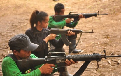 <p><strong>TRAINING WITH COMMUNISTS.</strong> Alexandrea “Alexa” Pacalda (middle) is seen undergoing weapons training with the New People's Army, in this undated photo recovered from communist rebels in an encounter with military troops in Quezon Province. Pacalda, 24, surrendered to authorities in General Luna town, Quezon on Sept. 14. <em>(Contributed photo)</em></p>