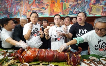 <p><strong>PORK CHALLENGE</strong>. Department of Agriculture (DA) Secretary William Dar (third from left), Manila Mayor Isko Moreno (3rd from right), and Samahang Industriya ng Agrikultura (SINAG) chairman Rosendo So (second from right), partake in a "boodle fight" (pork challenge) to show the public that eating pork in the Philippines is safe. The event was held at Manila City Hall on Monday (Sept. 30, 2019).  <em>(PNA photo by Ben Briones)</em></p>