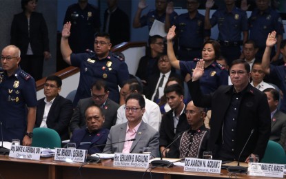 <p><strong>SENATE PROBE ON 'NINJA</strong> COPS'. Philippine National Police chief, Gen. Oscar Albayalde (left), PDEA Director General Aaron Aquino (right), take their oath before the Senate body investigating on the alleged drug recycling scheme involving "ninja cops”. Aquino confirmed on Thursday (Oct. 3, 2019) that Albayalde asked him not to implement the dismissal order against 13 alleged “ninja cops”. <em>(PNA photo by Avito C. Dalan)</em></p>
<p><em> </em></p>