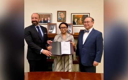 <p><strong>PH-INDONESIA EEZ PACT.</strong> Foreign Affairs Secretary Teodoro Locsin, Jr. (right) and Indonesian Foreign Minister Retno Marsudi submit the official copy of the 2014 agreement establishing the boundary between the Philippines and Indonesia's overlapping exclusive economic zones and respective instruments of ratification to UN Undersecretary-General for Legal Affairs Miguel de Serpa Soares (left) at the UN Headquarters in New York last week. The agreement was formally signed by the two countries in May 2014 in Manila and was ratified by President Rodrigo R. Duterte in February 2017 and by the Indonesian Parliament in April 2017. <em>(Photo courtesy of the Department of Foreign Affairs) </em></p>