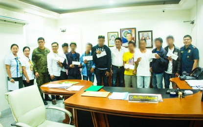 <p><strong>FIREARMS REMUNERATION.</strong> Davao Oriental Governor Nelson Dayanghirang (6th from right) leads the awarding of checks amounting to over PHP1 million to eight former members of the New People's Army (NPA) at the Provincial Capitol in Mati City on Tuesday (Oct. 1, 2019). Aside from the firearms remuneration, the ex-NPAs also received benefits under the Enhanced Comprehensive Local Integration Program. <em>(Contributed Photo)</em></p>