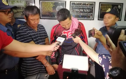 <p><strong>DRUG SUSPECTS</strong>. Police Staff Sergeant Elcelito Colita (right), desk officer of Marilog Police Station in Davao City, and Glenn Art Laurel Muring (in stripe shirt), are presented to the media on Thursday morning (October 3) following their arrest during a buy-bust operation on Wednesday evening. The two suspects were placed under the custody of Talomo police station for filing of appropriate charges for violation of RA 9165 or the Comprehensive Dangerous Drugs Act of 2002. <em>(PNA Photo by Che Palicte) </em></p>