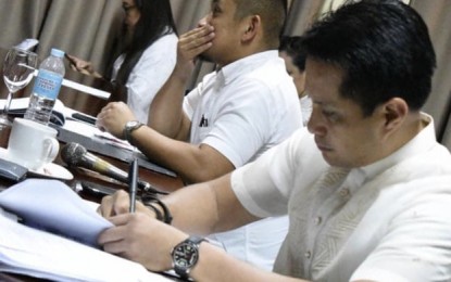 <p><strong>INVESTMENT SCAM.</strong> Glenn Anthony Soco, chair of the committee on commerce and industry of Cebu's Provincial Board, writes down notes during their recent session. On Thursday (Oct. 3, 2019), he said he plans to propose a task force that will run against establishments victimizing Cebuanos through investment scams. <em>(Photo from Glenn Anthony Soco's Facebook page)</em></p>