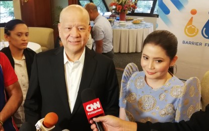 <p>SMC president and COO Ramon Ang and Tourism Secretary Bernadette Romulo-Puyat talk to reporters in Mandaluyong City. <em>(Photo by Joyce Ann L. Rocamora)</em></p>