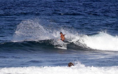 <p><strong>SURFING IN SIARGAO</strong>. A surfer maneuvers through a huge wave off Siargao Island on Friday (Oct. 4, 2019). The island will host the 25th Siargao International Surfing Cup, which will formally open at the Cloud 9 surfing haven in General Luna town at 3 p.m. on Saturday (Oct. 5, 2019). <em>(Photo by Alexander D. Lopez)</em></p>