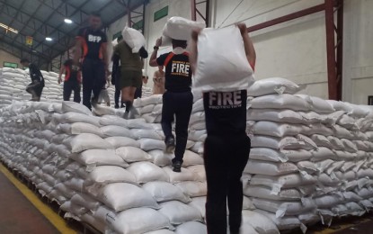 <p><strong>RICE ASSISTANCE.</strong> Personnel of the Bureau of Fire Protection help in the distribution of emergency rice assistance to the typhoon victims in Ilocos Norte last Saturday (Oct. 5, 2019). The province was submerged in flood waters last August which killed animals, destroyed public infrastructure projects, and washed out farmlands worth more than PHP231.6 million. The rice aid from the Japanese government greatly helped the calamity victims in meeting their basic food needs. <em>(Photo courtesy of NFA-Ilocos Norte)</em></p>