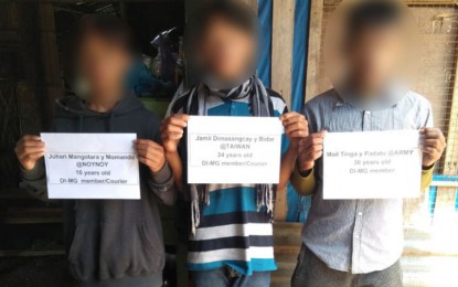 <p><strong>SURRENDERED.</strong> A teenage member of the Dawlah Islamiyah and two others surrender on Monday (Oct. 7, 2019) to military troops in Lanao del Sur. They yielded two caliber .45 pistols and an M-79 grenade launcher. <em>(Photo courtesy of the Army's 1st Infantry Division)</em></p>