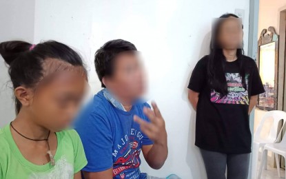 <p><strong>SEEKING JUSTICE.</strong> The 14-year-old rape victim (left) with her parents at the police station in Caibiran, Biliran. Two other victims also sought the assistance of the local police to file charges against the same rape suspect. <em>(PNA photo by Roel Amazona</em></p>
