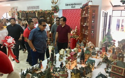 <p><strong>GARDEN OF SANTAS.</strong> Narvacan Mayor Luis “Chavit" Singson (in blue) leads the ceremonial opening of the “Garden of Santas” at the second floor of the municipal hall on Wednesday (Oct. 9, 2019). Vice Mayor Pablito Sanidad’s wife, Susan Sanidad, shared her 20-year-old collection of Santa Claus figures to the townspeople, among them “Sporty Santa”, “Climbing Santa”, “Tarzan Santa”, and “Lover-Boy Santa”. <em>(Photo by Leilanie G. Adriano)</em></p>