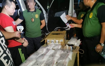 <p><strong>QC SHABU HAUL.</strong> Personnel from PDEA National Capital Region inspect packs of shabu seized from suspect Hongbo He (left), who was arrested in a buy-bust operation at the QC Memorial Circle Complex on Tuesday (Oct. 8, 2019). The suspect yielded 15 pieces of transparent plastic packs of suspected shabu weighing around 15 kilos and valued at PHP102 million. <em>(Photo courtesy of PDEA-NCR)</em></p>